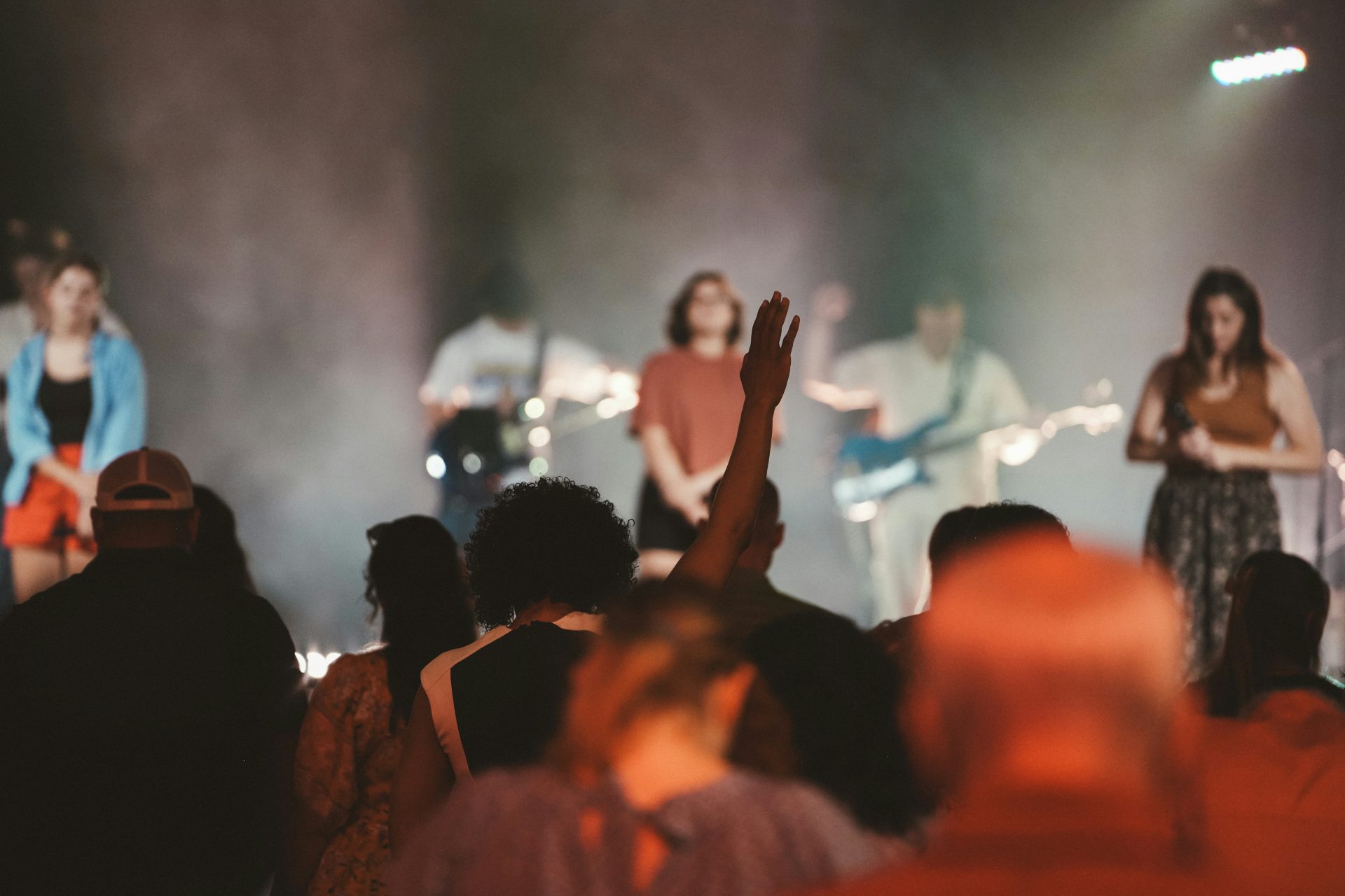 Audience enjoys a concert with the band on stage.